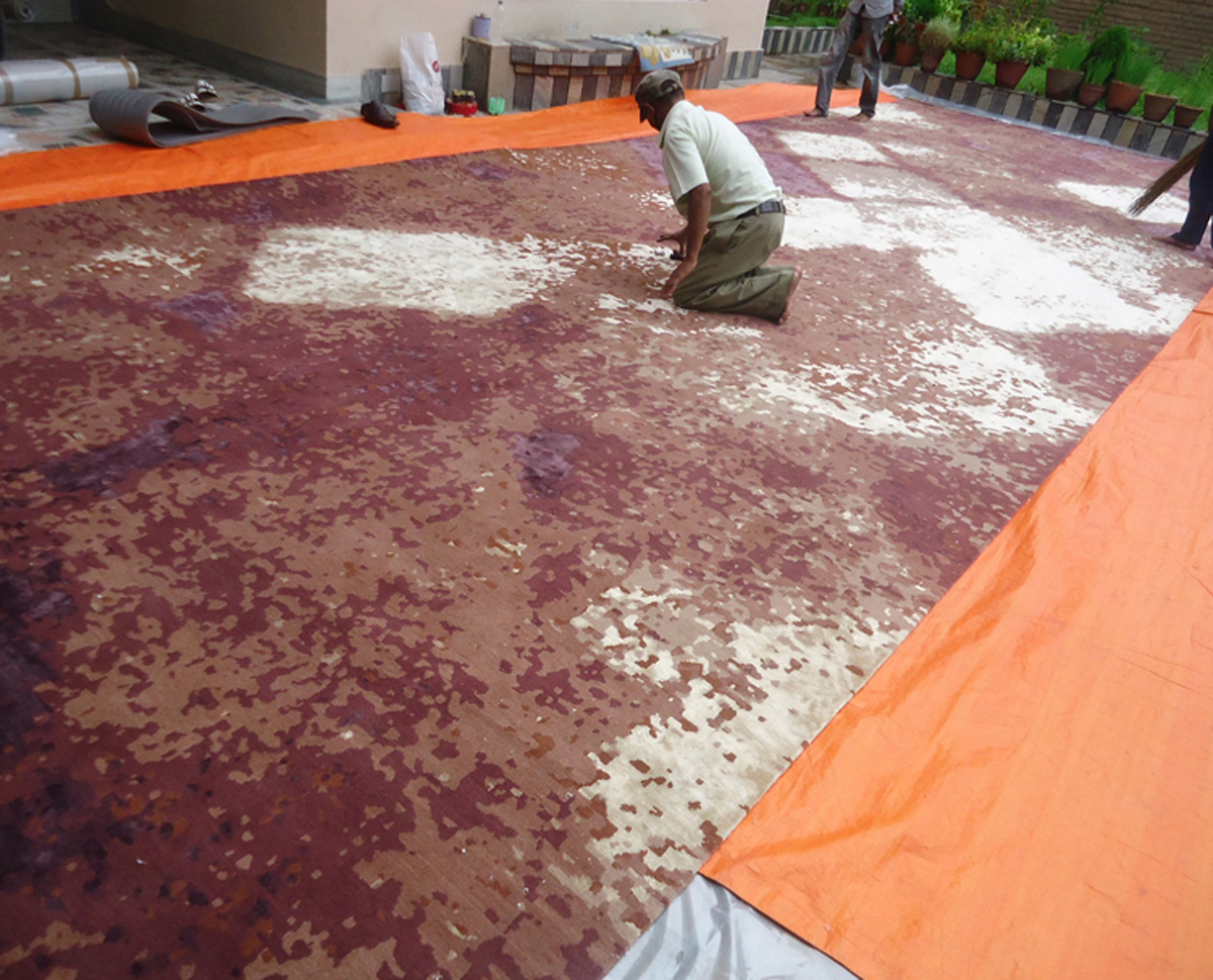 Rug Manufacturing - Inspecting finished custom Wool and Silk rug in Nepal