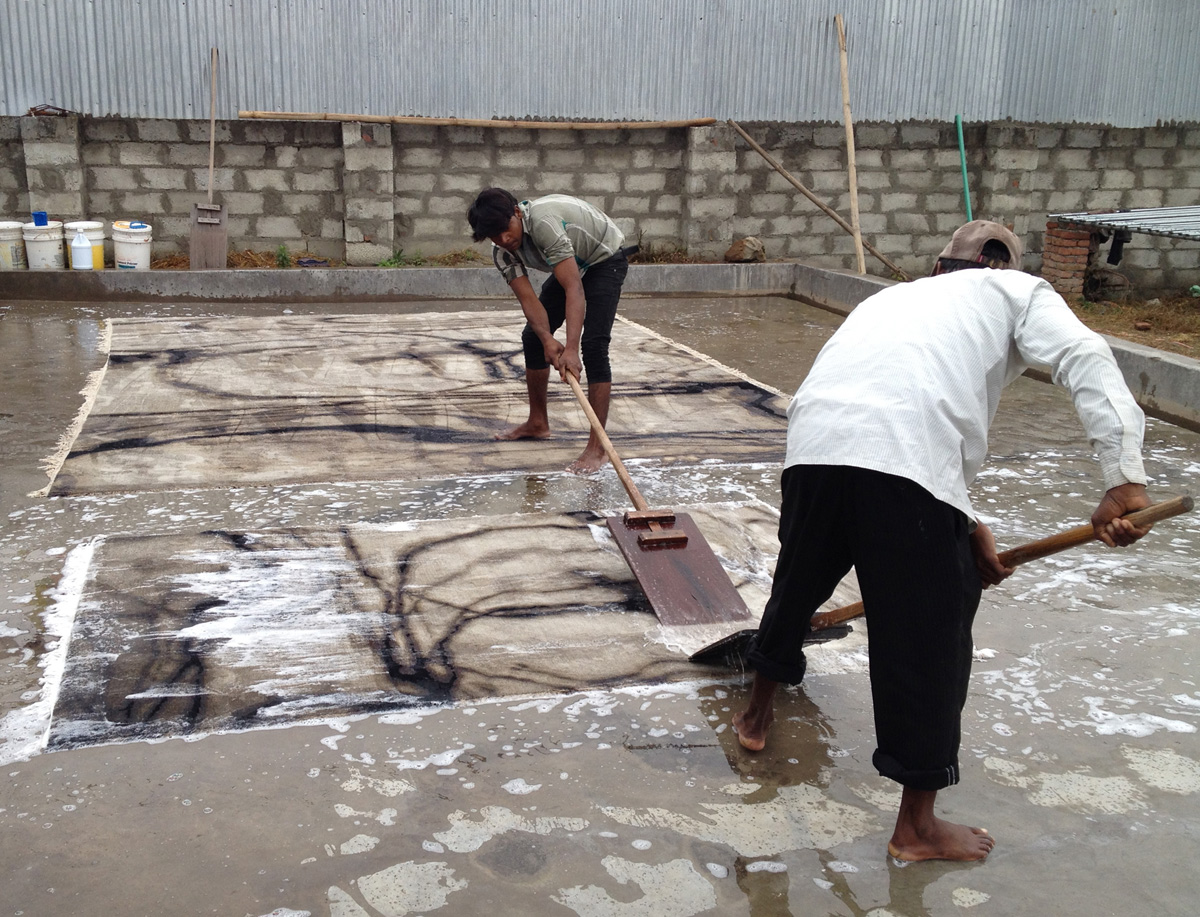 Rug Manufacturing - Washing Waterlines Wool and Silk rugs by hand in Nepal